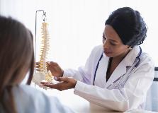 Chiropractor explaining treatment to her patient