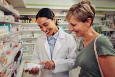 Customer in a pharmacy being helped by the pharmacist
